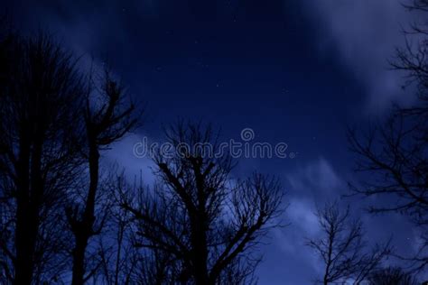 View Of Stars In A Clear Night Sky With Motion In Clouds Moving Acroos