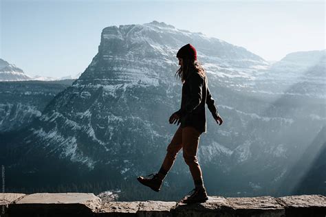 "Woman Walking Along Ledge" by Stocksy Contributor "Caleb Gaskins ...