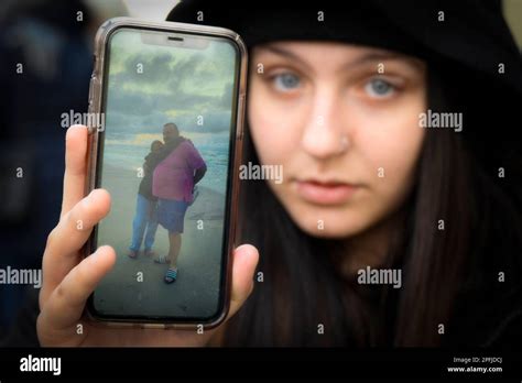 The Daughter Of Mariusz Dworakowski Oliwia Holds Up A Photo Of Her Father During A Rally In