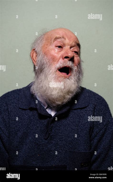 Isolated Portrait Of Caucasian Bald Old Man With Mouth Open And Long