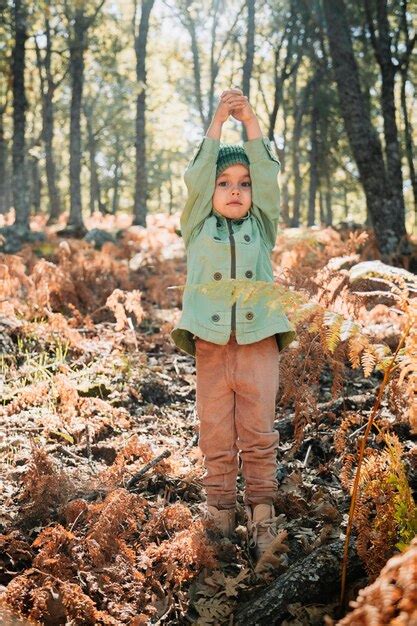 Premium Photo Full Length Portrait Of Girl Standing Against Trees In