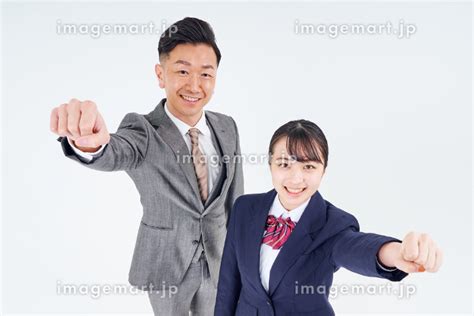 ガッツポーズをするスーツ姿の日本人男性と女子高生 （人物）の写真素材 211363800 イメージマート