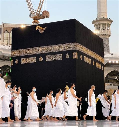 A Group Of People In White Robes Walk Around The Ka Ba Which Is