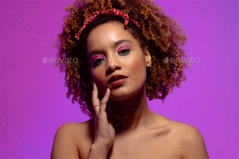 Biracial Woman With Curly Hair Pink Eye Shadow And Lipstick Touching