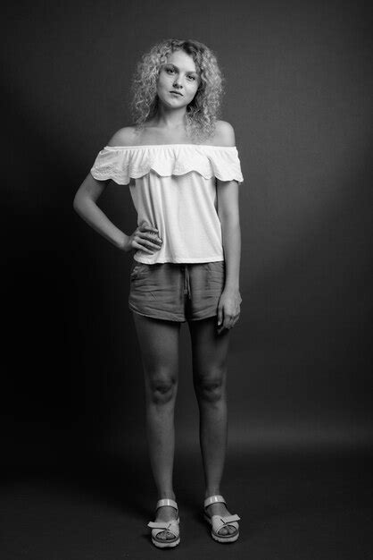 Premium Photo Portrait Of Teenage Girl Standing Against Black Background