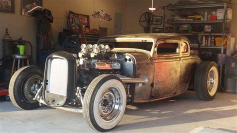 An Old Car Is Parked In A Garage