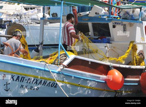 Greek Fishermen Working With Nets On The Greek Island Of Ios Stock