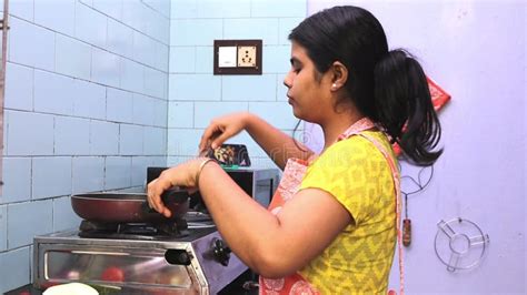 Indian Housewife Doing Housework Washing Bath Towels In Laundry Room