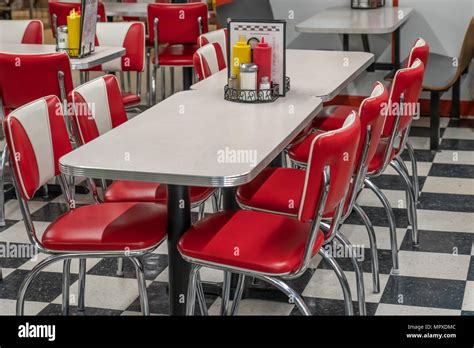 50s Style Diner With Black And White Tile Floor Red Vinyl Chairs And