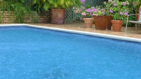 rain falling  swimming pool stock video motion array