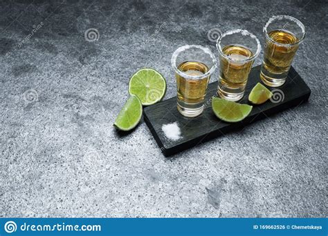 Mexican Tequila Shots Lime Slices And Salt On Grey Table Stock Photo