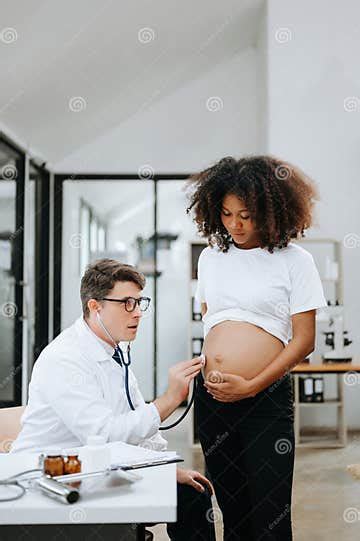 Pregnant African Woman Has Appointment With Doctor At Clinic Male