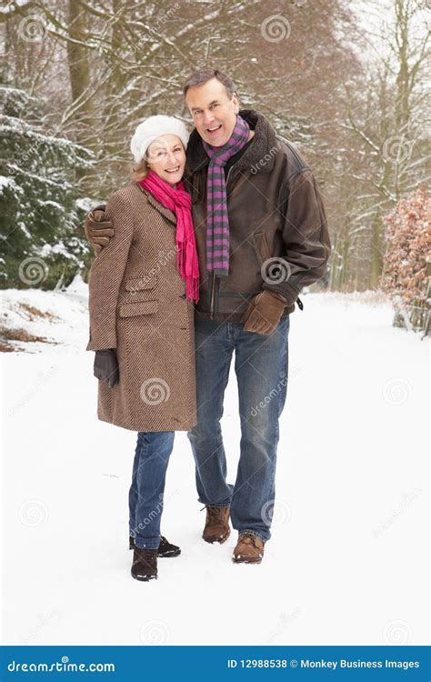 Senior Couple Walking Through Snowy Woodland Stock Photo Image Of