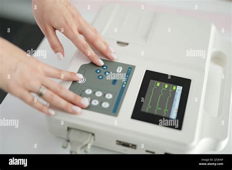 Woman cardiologist doctor makes electrocardiography procedure using ...