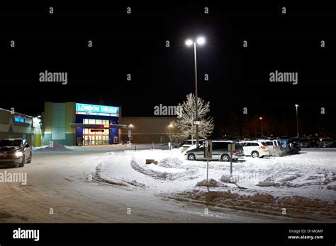 snow covered outside parking lot at night outside a shopping mall ...