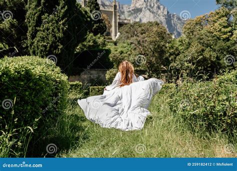 A Beautiful Woman With Long Brown Hair And Long White Dress Stay Along