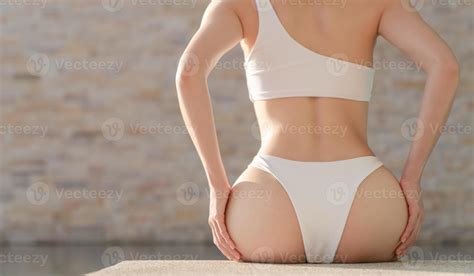 Woman In White Bikini With Big Beautiful Booty Sitting On The Edge Of