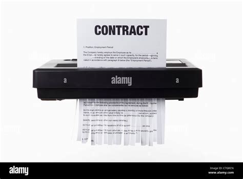 An Employment Contract Being Shredded In A Paper Shredder Stock Photo