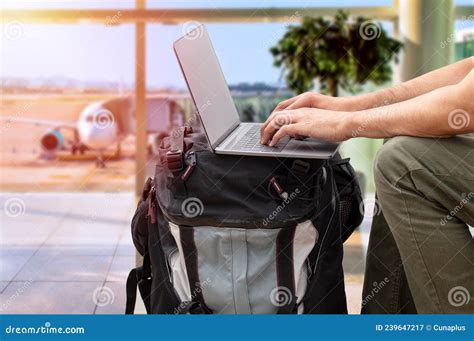 Digital Nomad Sitting Alone And Typing On His Laptop Stock Photo