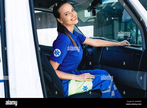 Emergency Medical Services Worker Portrait Of Female Paramedic Sitting Inside Ambulance Stock