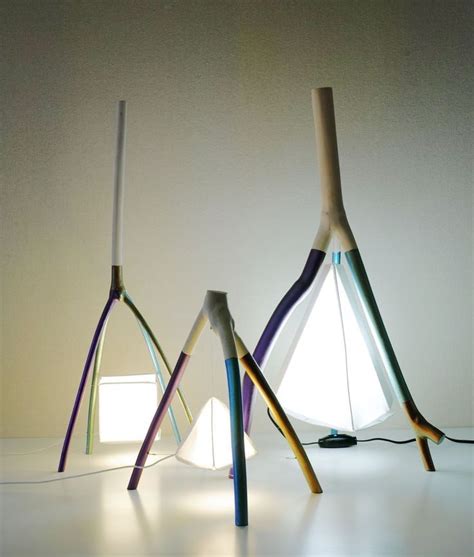 Three Different Colored Lamps Sitting Next To Each Other On A White