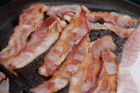 Free Stock Photo of Bacon Strips Cooking in Frying Pan