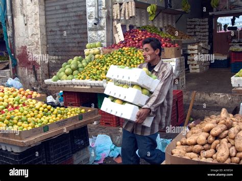 Fruit Stand And Male Vendor Working Fruit And Vegetable Market Amman