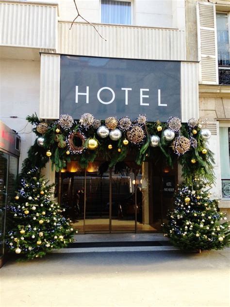 The Entrance To A Hotel Decorated For Christmas