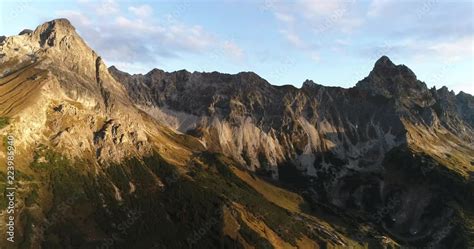 Cinematic view of alps mountain ridge and summit peak Zimba, Austria during sunrise. Drone ...