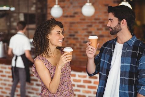 Premium Photo Smiling Hipster Couple With Take Away Cups