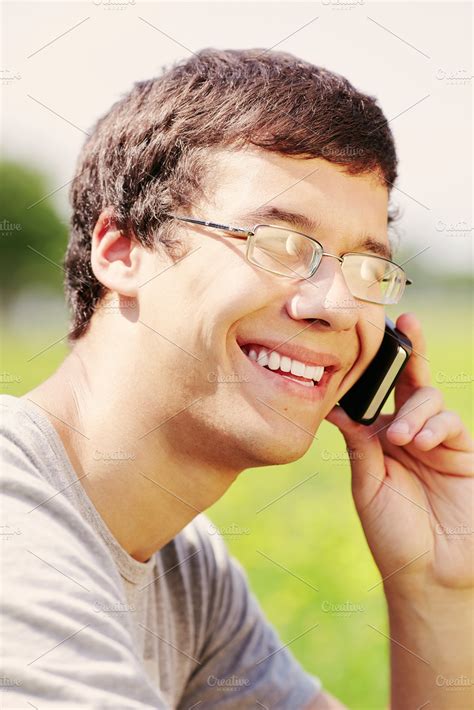 Guy talking on mobile phone containing cell phone, cheerful, and close ...