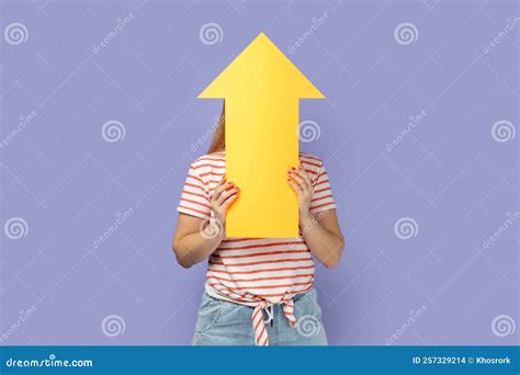 Unknown Woman Holding Big Yellow Arrow Pointing Up Showing Increase In