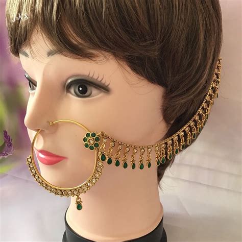 A Mannequin Head With A Pair Of Earrings On It S Ear And Nose