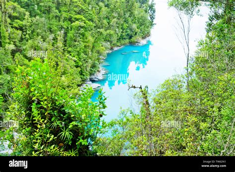 Blue Pond With Bridge In Green Forest Stock Photo Alamy