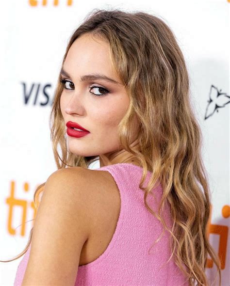 A Close Up Of A Person With Long Hair Wearing A Pink Dress And Red Lipstick