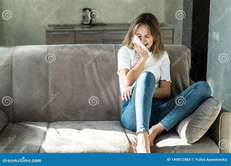 Sad Young Woman Sitting On The Couch At Home And Crying Stock Image