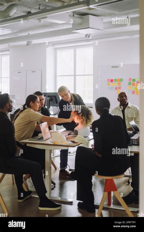 Female Mature Professor Explaining Multiracial Students Over Robot Stock Photo Alamy