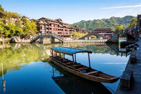 Parked Wooden Tourist Boat On The Tuojiang River And Amazing Bridge