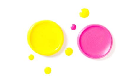 Premium Photo | Yellow and pink acrylic paint drops on white