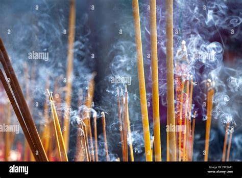 Many Scented Incense Sticks Burning In A Buddhist Shrine Creating A