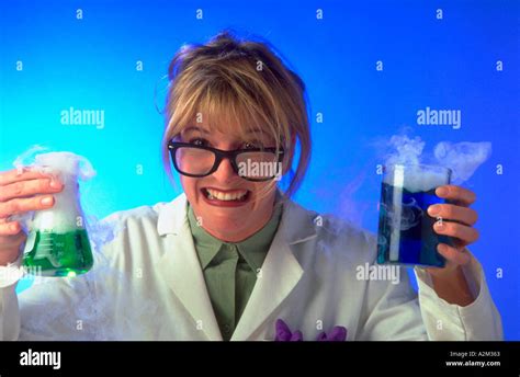 Portrait of a mad female scientist holding beakers with colored fluids ...