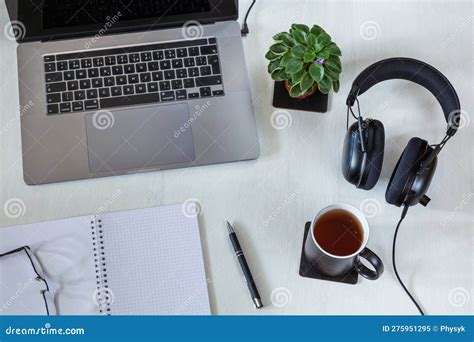 Workplace With Laptop Notepad And Cup Of Tea On White Desktop Stock