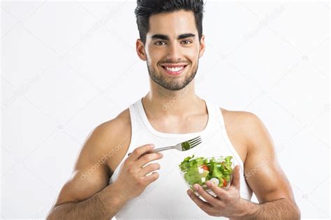 Healthy man eating a healthy salad — Stock Photo © ikostudio #75196793