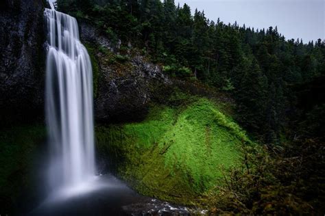 Free Stock Photo Of Majestic Waterfall Towering Over Lush Green Forest