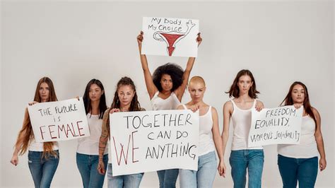 Group Of Serious Diverse Women In White Shirt And Casual Denim Jeans