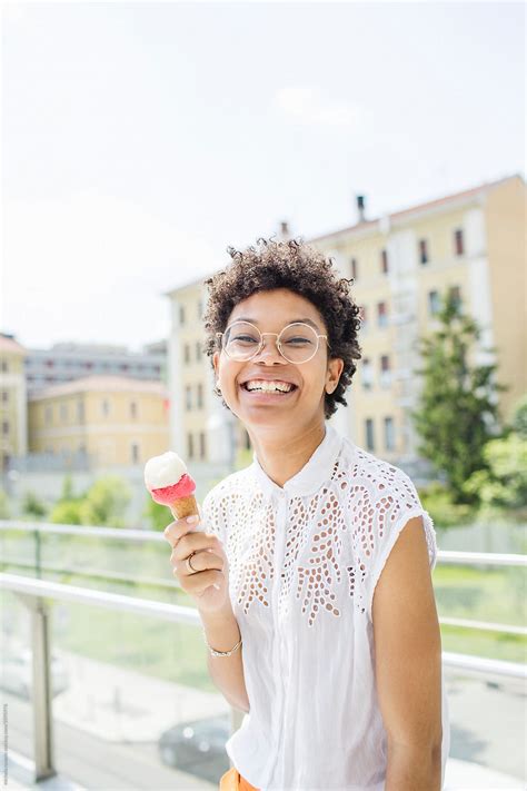 Smiling Woman Eating An Ice Cream By Stocksy Contributor Michela