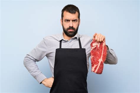 Premium Photo Chef Holding A Raw Meat Angry