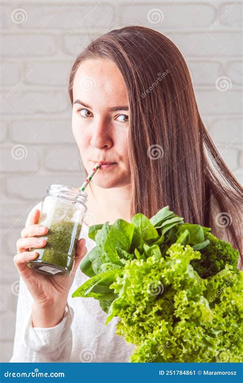 Beautiful Young Smiling Woman Is Drinking Green Detox Shake Stock Image