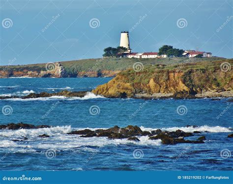 A Lighthouse Perched On A Rocky Shore Stock Photo Image Of Rock