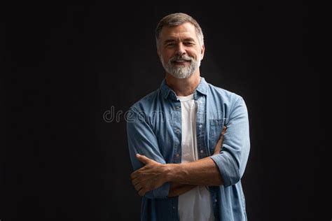 Portrait Of Smiling Mature Man Standing On White Background Stock Image